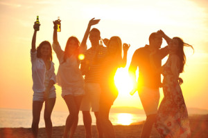 Group of young people enjoy summer  party at the beach