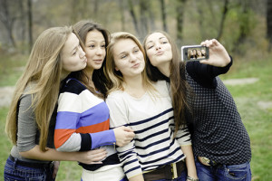 Four teen girls taking picture of themselves