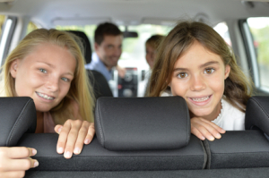 Portrait of young girls in car ready for car trip